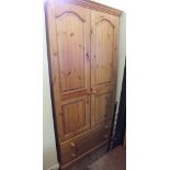 A modern Pine two door wardrobe over two drawers