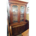 A Victorian Mahogany glazed bookcase with double door base