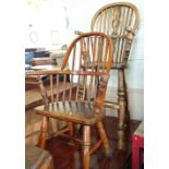 A child's wheel back high chair and an Elm comb back child's chair