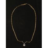 An 18ct Yellow Gold ball and link chain with White Gold diamond set pendant