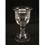 A Georgian baluster wine glass with double ogee bowl, wrythen stem and folded foot,