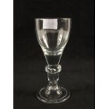 A Georgian wine glass with ovoid bowl, annular knop and teardrop on domed foot,