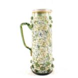 A 19th Century green Bohemian glass jug with enamel leaf decoration and applied roundels