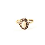 A 9ct Gold Opal ring surrounded by white stones,