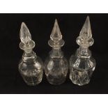 Five 19th Century cut glass decanters and a claret jug