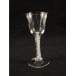 A Georgian wine glass with ogee bowl on plain stem with opaque gauze spiral twists on conical foot,