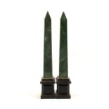 A pair of Holkham pottery green and black obelisks,