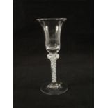 A Georgian wine glass with waisted bowl on single knopped stem with opaque spiral gauze surrounded