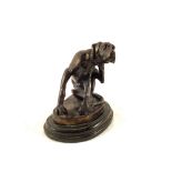 A Bronze of a seated dog scratching his ear,