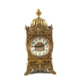 A French mantel clock with enamel dial in pierced Brass case