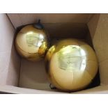 Two gold coloured witches balls