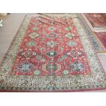 A Caucasian red ground carpet with geometric medallions,