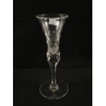 A large 19th Century wine glass with facetted trumpet bowl and stem,