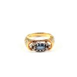 A 14ct Gold Sapphire and Diamond set ring with bark effect shoulders,