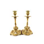 A pair of heavy 19th Century aesthetic movement Brass candlesticks ornately cast with openwork and
