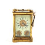 A Brass carriage clock with day and month calendar dials