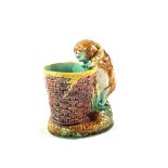 A 19th Century Mintons Majolica kitten peering into baskets (two chips)