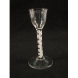 A Georgian wine glass with ogee bowl on plain stem with opaque spiral gauze surrounded by spiral