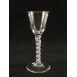 A Georgian wine glass with ogee bowl on plain stem with opaque twist surrounded by spiral threads