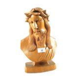 A wooden carving of a head and shoulders of Christ,