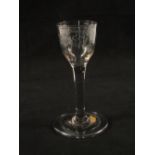 A Georgian wine glass with ogee lead engraved bowl on plain stem and folded foot,