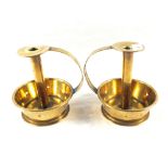 A pair of Arts and Crafts Brass chambersticks with deep dished circular bases having pierced