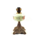 An Iron base painted milk glass oil lamp