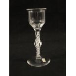 A Georgian wine glass with flared top ogee bowl on single knopped stem with opaque gauze twist