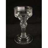 A Georgian wine glass with ogee bowl, octagonal moulded stem and folded foot,