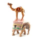 A carved and painted wooden elephant and a leather camel