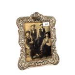 A large Silver photo frame with floral decoration, 11 1/2" x 9 1/2",