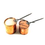 A graduated pair of 19th Century oval seamed Copper saucepans and lids with iron handles,