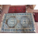Two Afghan prayer mats and a Turkish blue ground rug