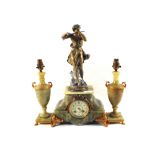 A French Onyx and gilt metal mantel clock with spelter flute player mount