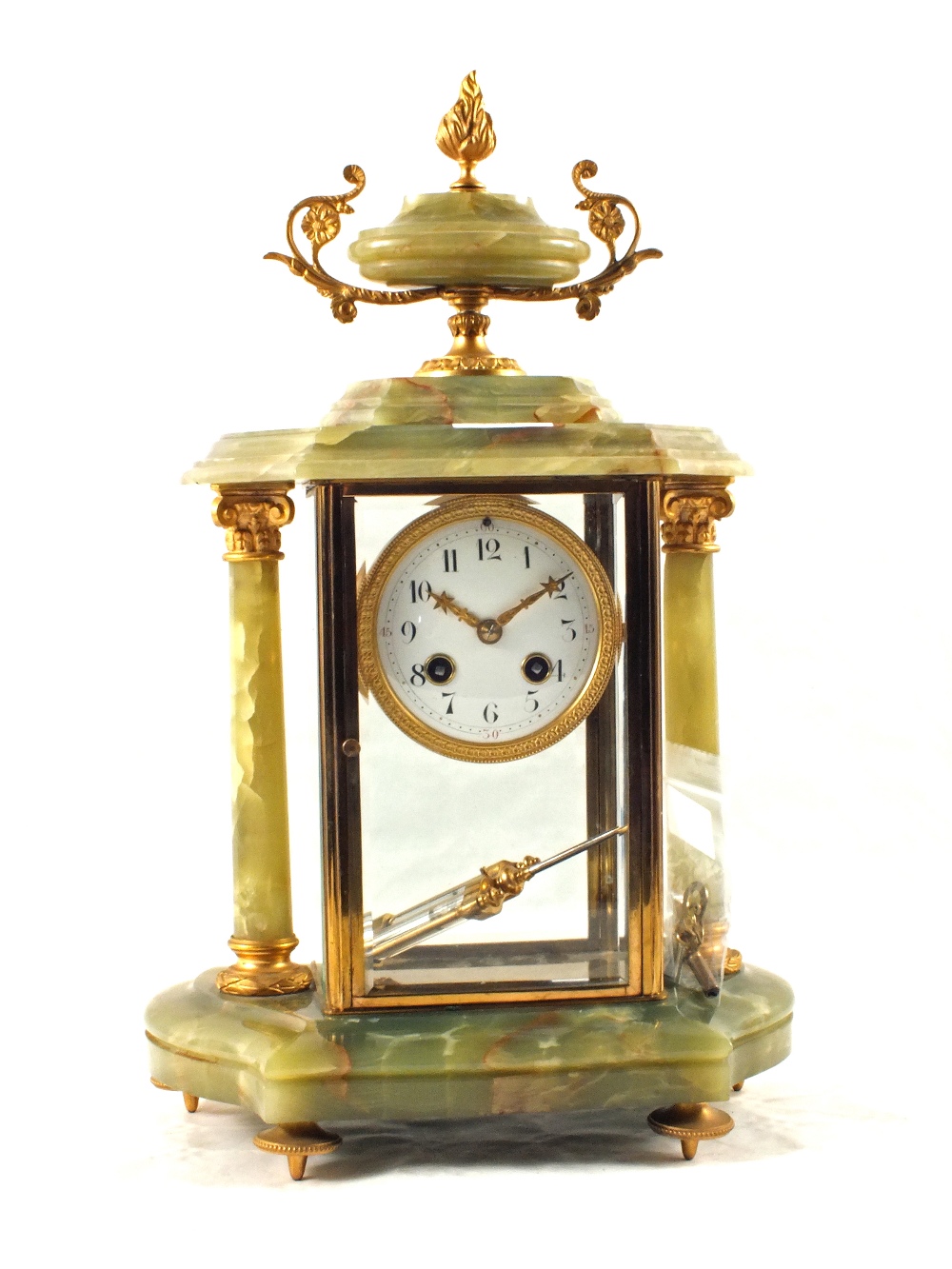 A French Onyx and gilt metal mantel clock with side columns and urn finial plus a pair of table