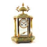 A French Onyx and gilt metal mantel clock with side columns and urn finial plus a pair of table