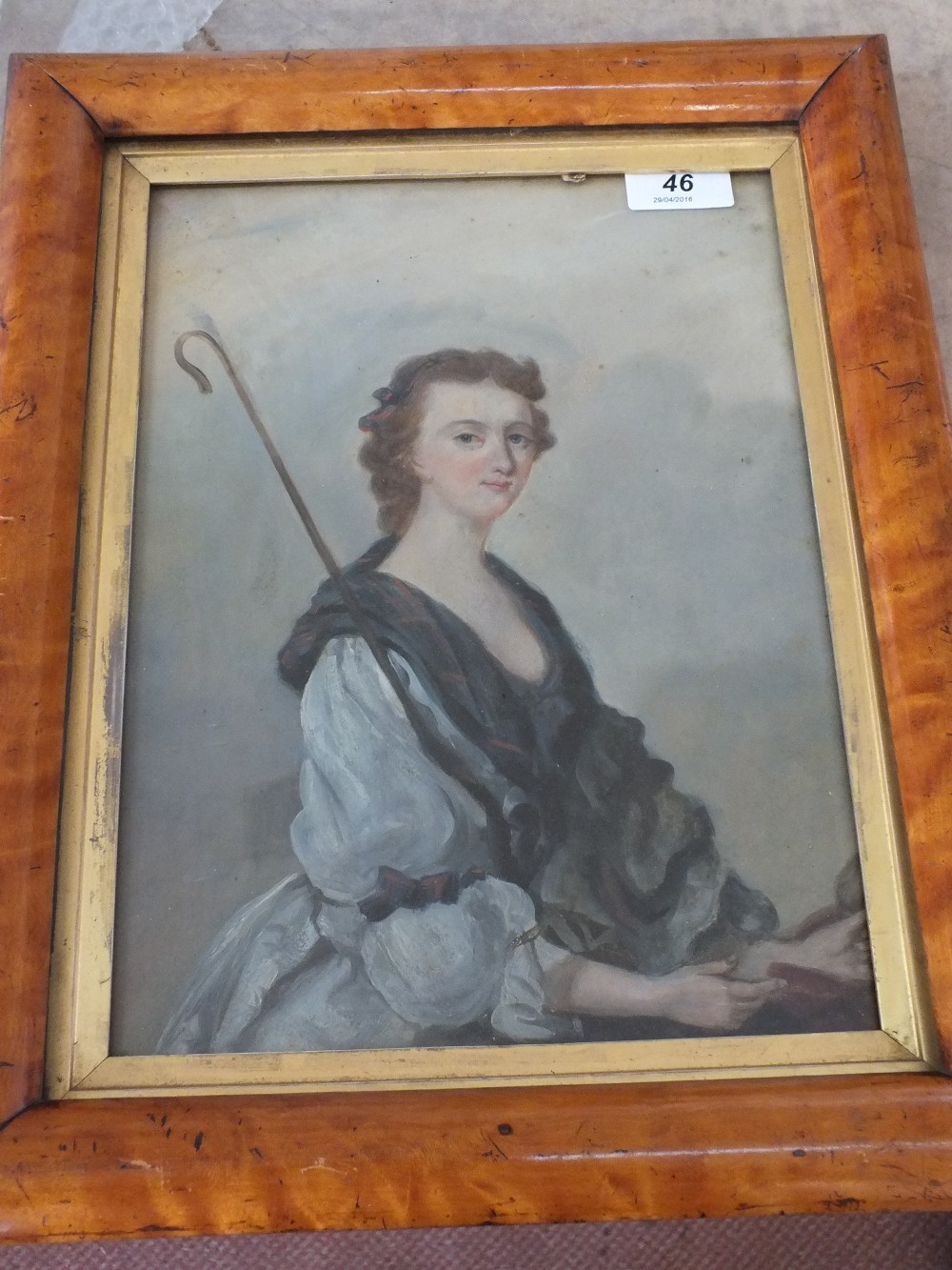 A maple framed oil on board, half length portrait of a shepherdess,
