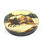 A Russian oval papier mache box painted with a horse drawn Troika and figures,