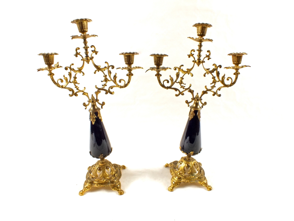 A pair of gilt metal and blue glass candelabra