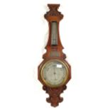 A carved Oak aneroid barometer plus one other (broken glass)