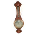 A carved Oak aneroid barometer (split glass)