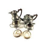 An Art Nouveau pewter tea set and a pair of glass Silver rim coasters