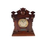 An American Oak Welch's mantel clock retailed by R.