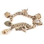 A Silver charm bracelet with seven charms