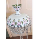 A white overlaid glass and floral painted droplet lightshade