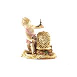 A Meissen figurine of a boy with birds and reticulated cage,