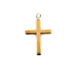 A yellow metal cross pendant