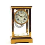 A Brass cased four glass striking mantel clock with painted enamel dial