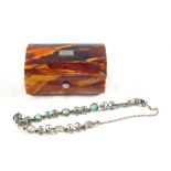 A Tortoiseshell snuff box containing Turquoise and Silver metal filigree bracelet