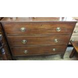 A Victorian chest of three long drawers on bracket feet